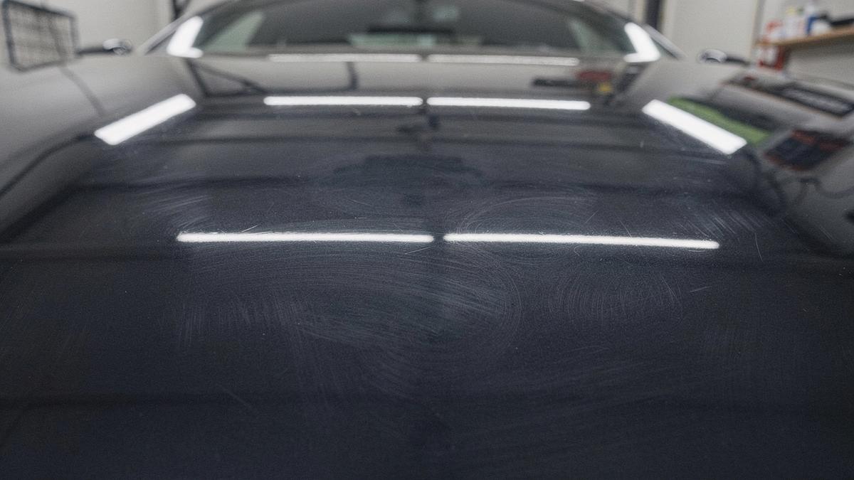 Before paint correction: swirled clear coat under studio lighting